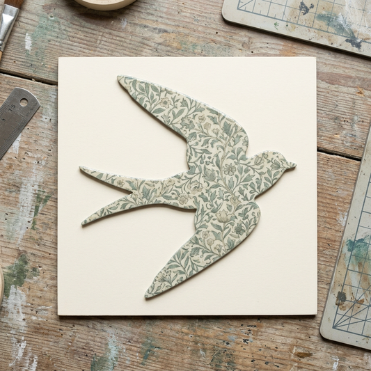 Botanical decoupage swallow on a backing board