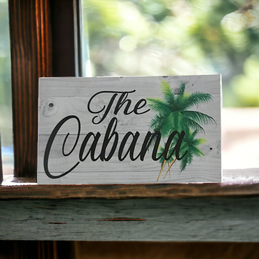 The Cabana with Palm Trees Sign