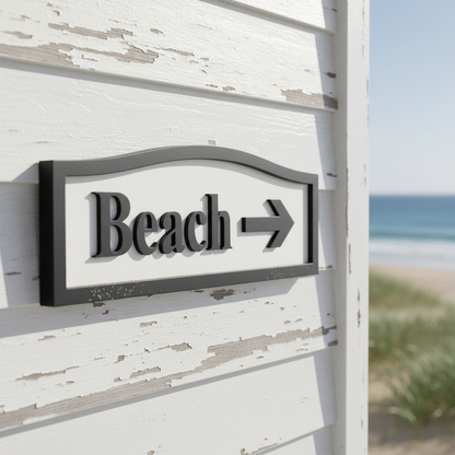 Directional sign pointing to the beach with an arrow on a white background