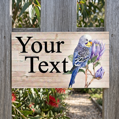 Blue budgie Your Text sign on a native-garden fence