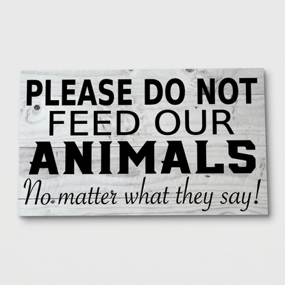 Do Not Feed Our Animals sign on light grey