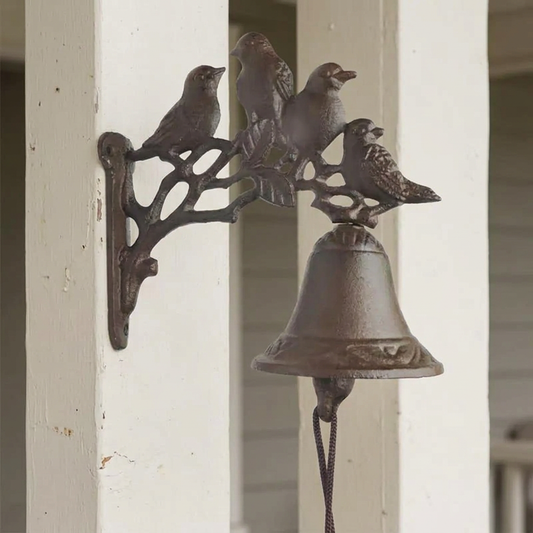 Four-bird doorbell on a plain painted porch post