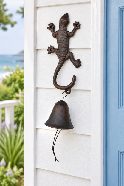Gecko cast iron doorbell beside a coastal cottage doorway