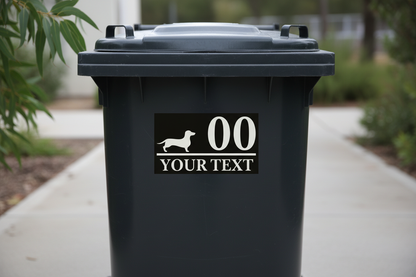 White background black text Your Text Dachshund sticker applied to a dark wheelie bin — personalised wheelie bin sticker, custom text, Aussie made