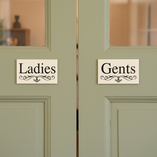 Ladies and Gents White Elegance cream signs on side-by-side cafe doors