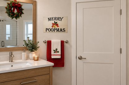 Merry Poopmas sign beside a bathroom mirror