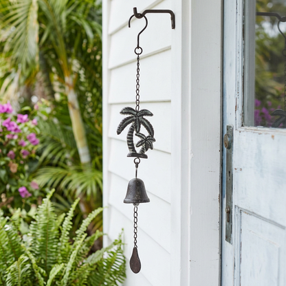 Palm tree cast iron bell beside a coastal cottage door