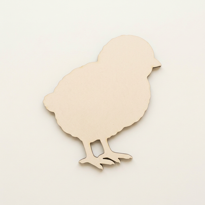 Raw MDF fluffy chick on a plain table