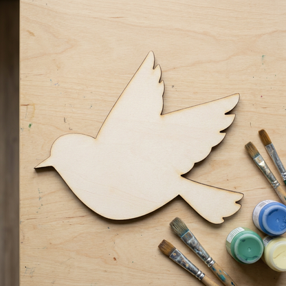 Raw MDF flying bird on a craft table
