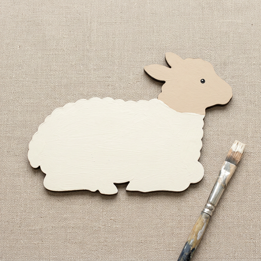 Resting lamb painted ivory and beige
