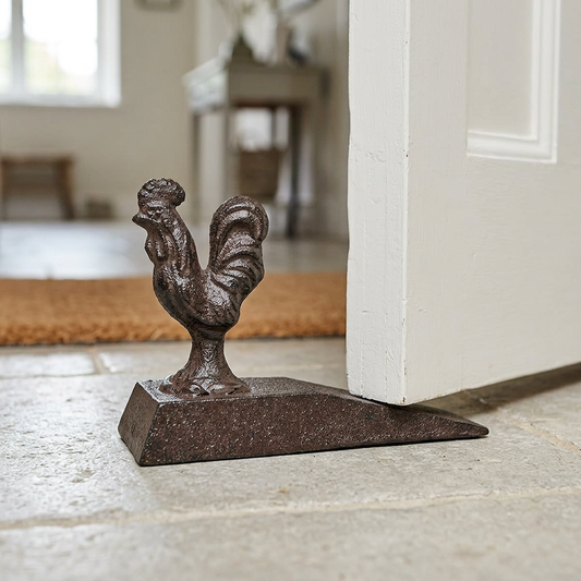 Rooster doorstop in a cottage hallway doorway