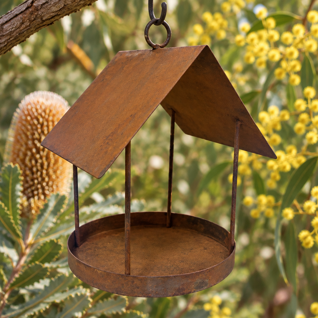 Rustic bird feeder in a banksia and wattle garden