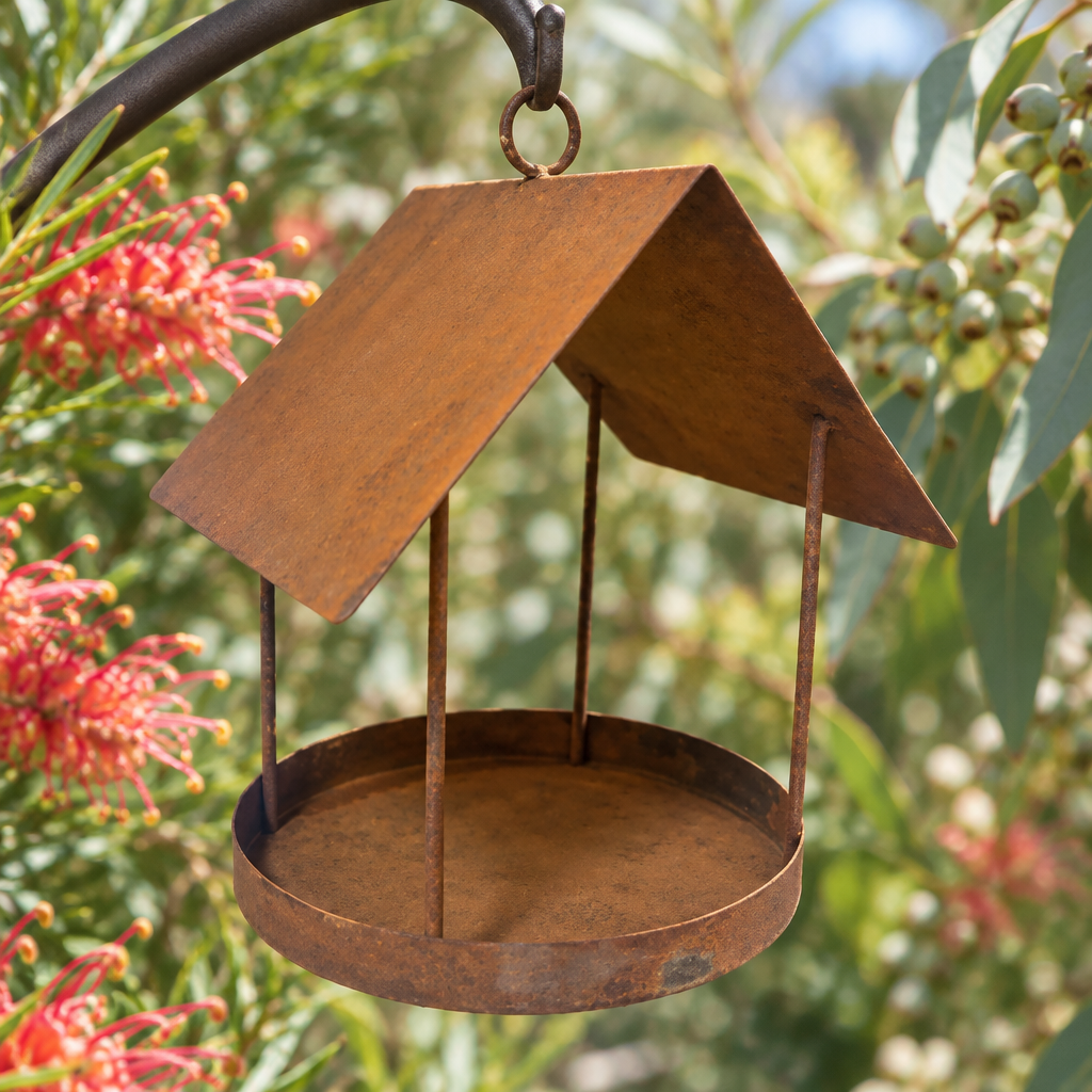Rustic bird feeder in a grevillea and eucalyptus garden
