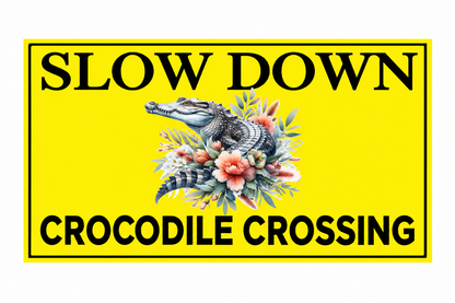 Slow Down Crocodile Crossing yellow sign with floral crocodile artwork on a white background