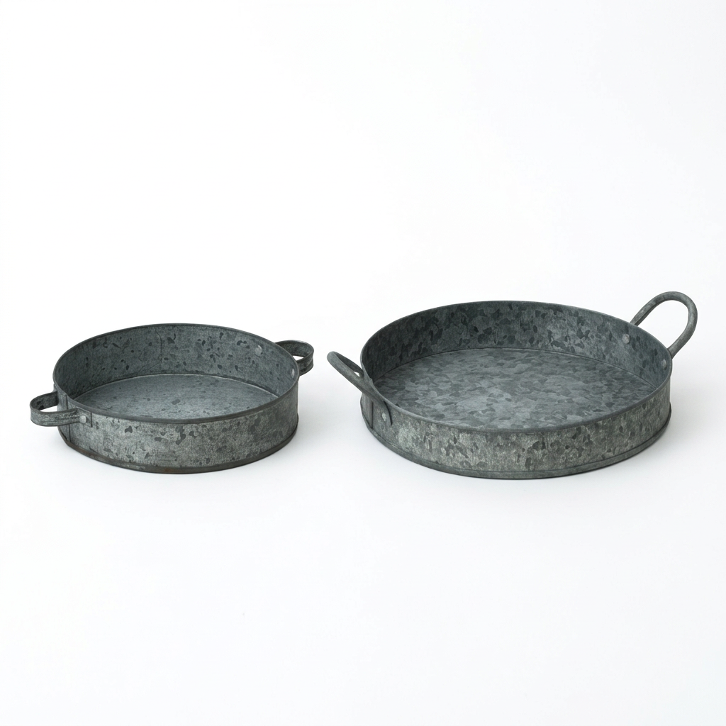 Small and large rustic round metal trays on a white background