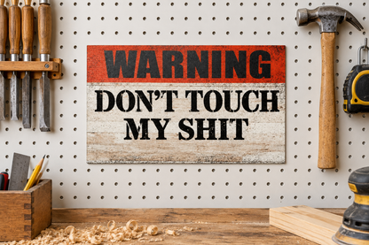 Square-corner warning sign on a workshop pegboard