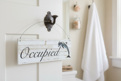 Straight-on dolphin bathroom sign on a hook