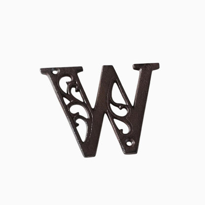 The Renmy Store Homewares & Gifts black cast iron letter W with a hollowed-out European retro design on a book page.
