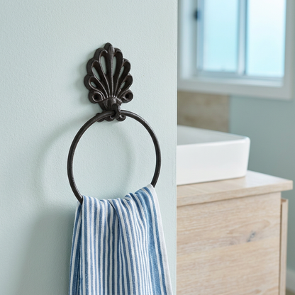 Towel ring in a seafoam beach-house bathroom with a striped towel