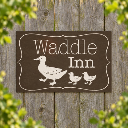 Waddle Inn duck sign on a weathered garden fence