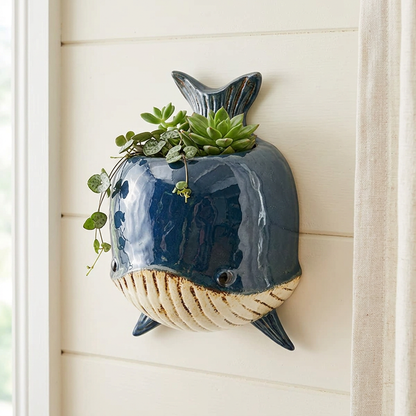 Whale wall planter on cream timber panelling in a coastal cottage
