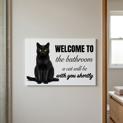 White cat bathroom sign beside a bathroom doorway