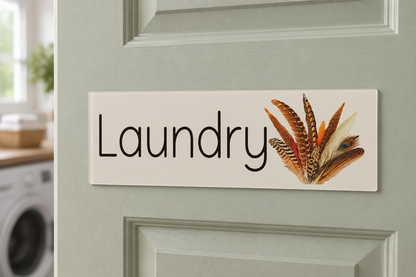 Wild Feathers Laundry sign on a pale sage door
